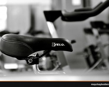 Detailed black and white shot of a gym bicycle saddle, highlighting fitness equipment aesthetics.
