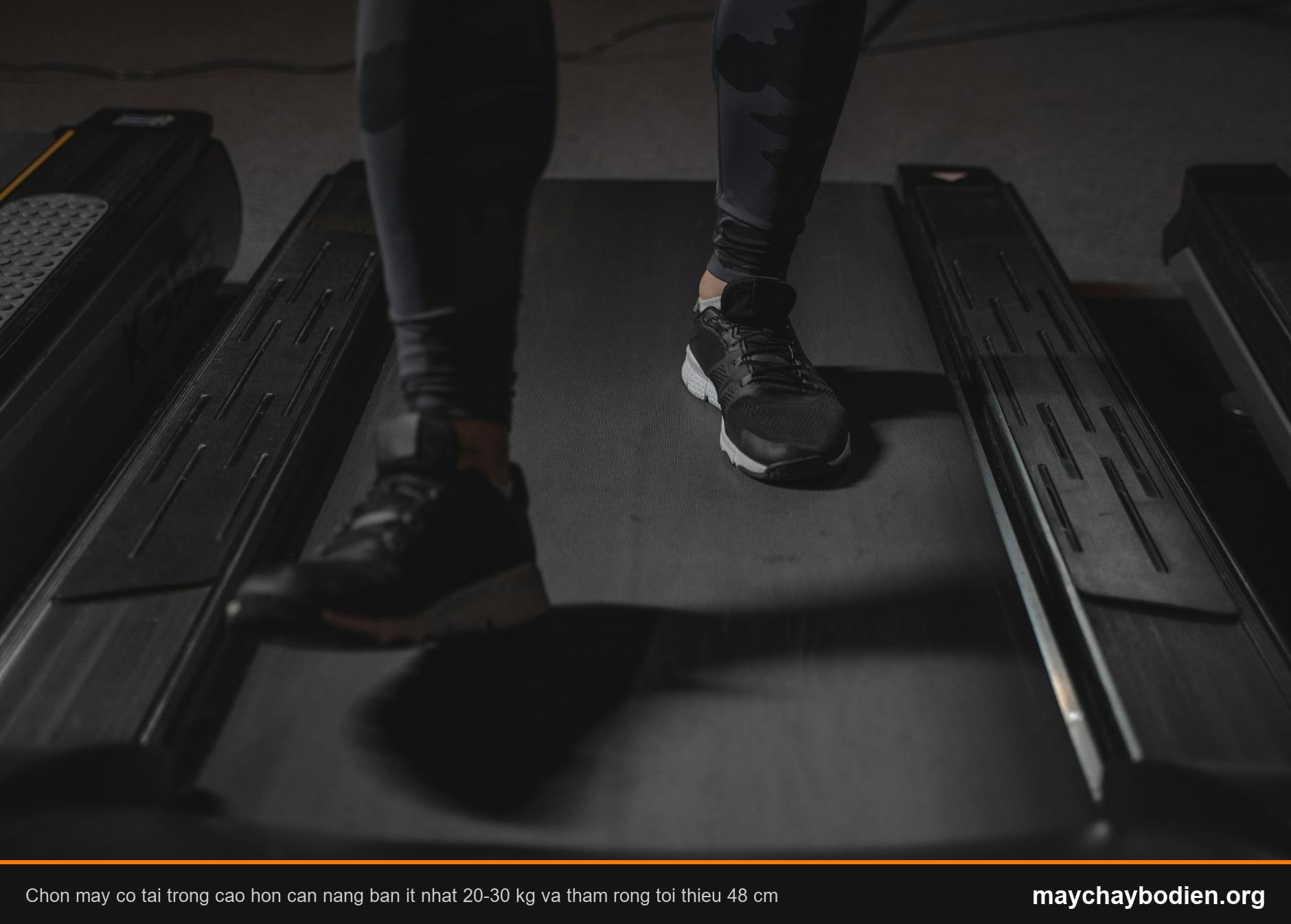 Feet running on treadmill in gym. Focus on black sneakers. Fitness and cardio exercise concept.