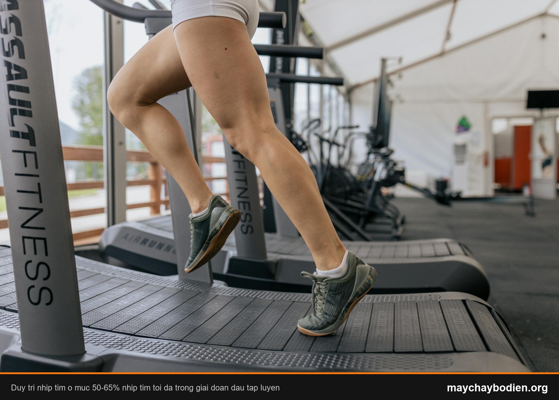 Close-up of a woman's legs running on a treadmill indoors, focusing on fitness and exercise.